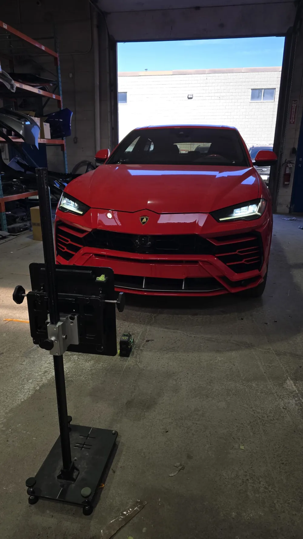 Red Lamborghini with ADAS calibration equipment in the workshop